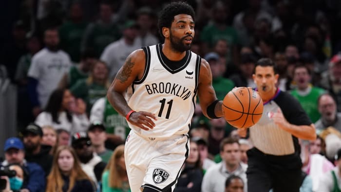 Brooklyn Nets guard Kyrie Irving (11) returns the ball against the Boston Celtics.